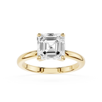 Gold ring with a large diamond on a white background