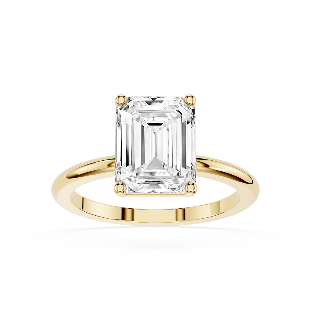 Gold ring with a large emerald-cut diamond on a white background