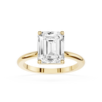 Gold ring with a large emerald-cut diamond on a white background