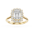 A yellow gold halo ring featuring a large emerald-cut center diamond surrounded by a double halo of smaller round diamonds, set on a polished gold band against a white background.