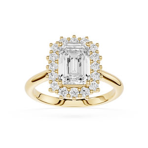 A yellow gold halo ring featuring a large emerald-cut center diamond surrounded by a double halo of smaller round diamonds, set on a polished gold band against a white background.