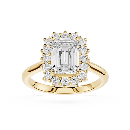 A yellow gold halo ring featuring a large emerald-cut center diamond surrounded by a double halo of smaller round diamonds, set on a polished gold band against a white background.