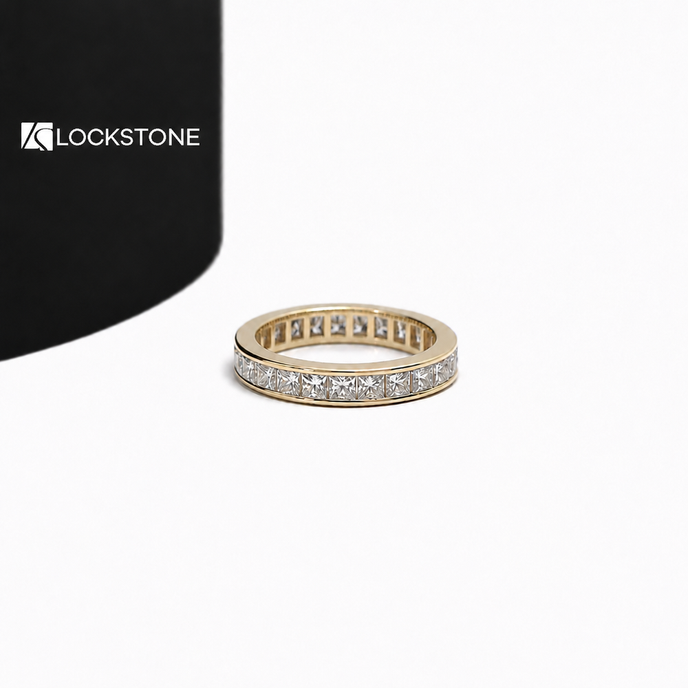 Yellow gold princess cut diamond eternity wedding band featuring a continuous row of channel set square diamonds