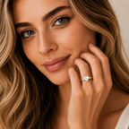 Woman wearing a diamond ring on her finger, with a soft focus background