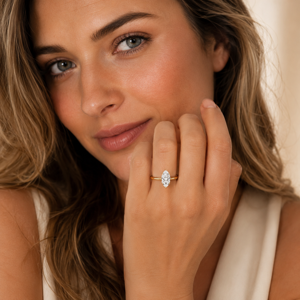 Woman wearing a gold ring with a diamond on her finger, close-up shot.