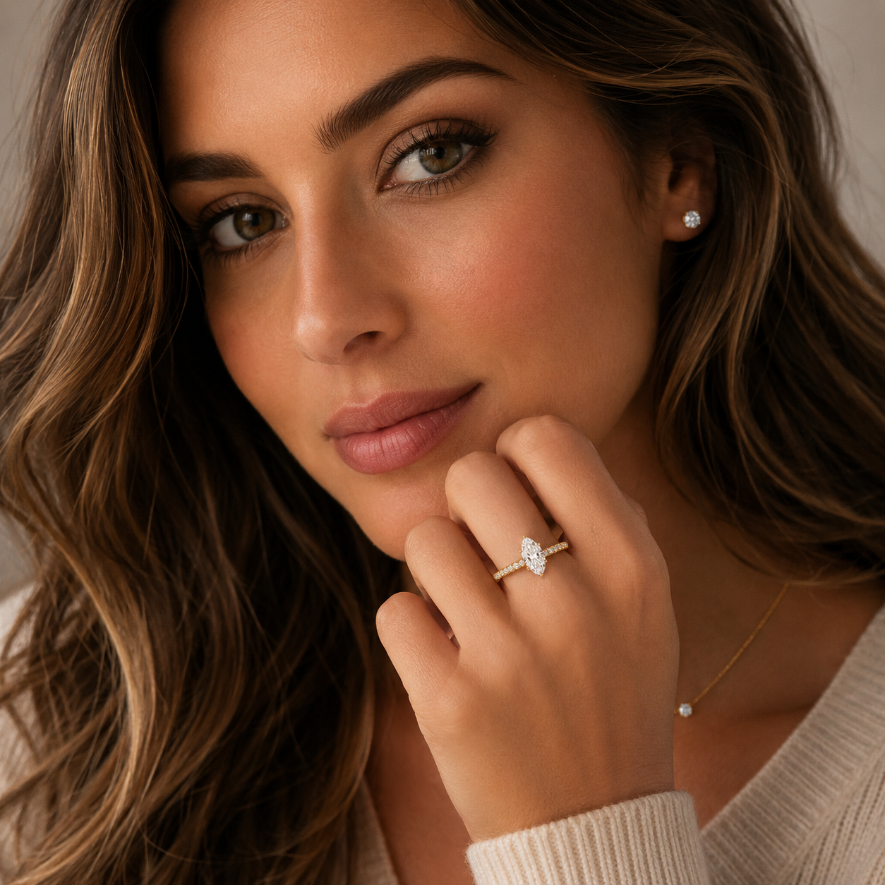 Woman wearing a diamond ring with a neutral background