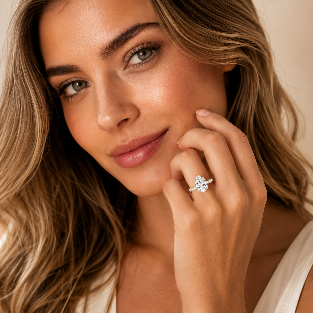 Woman wearing a diamond ring with a neutral background