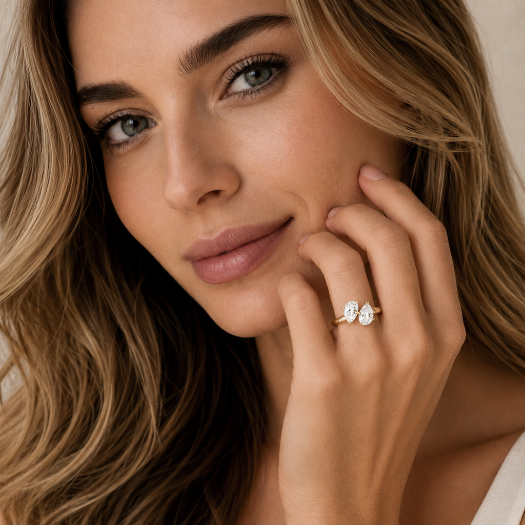 Woman wearing a diamond ring with a neutral background