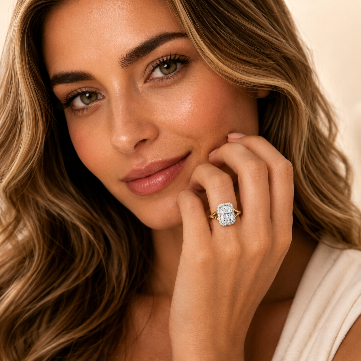 Woman wearing a diamond ring with a neutral background