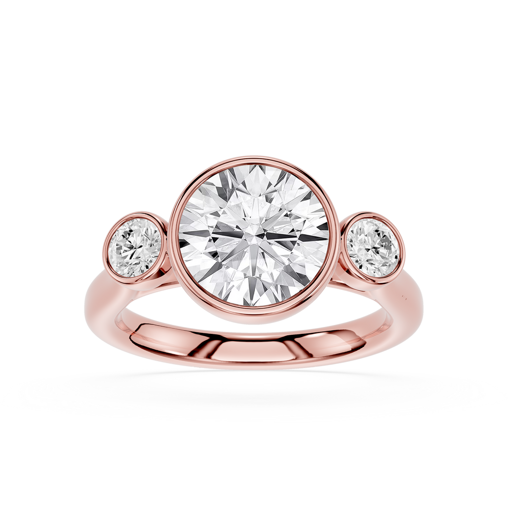Rose gold ring with a large central diamond and two smaller diamonds on either side against a white background.