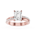 Rose gold ring with emerald-cut diamond and smaller diamonds on a white background