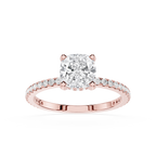 Rose gold ring with a large diamond and smaller diamonds on the band against a white background