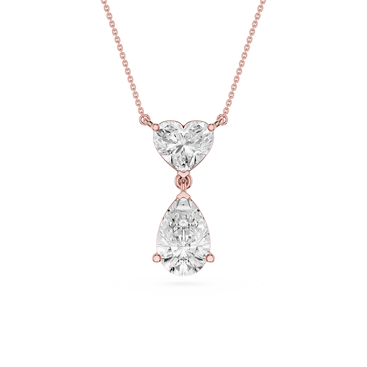 Rose gold necklace with a heart-shaped and teardrop-shaped diamond pendant on a white background