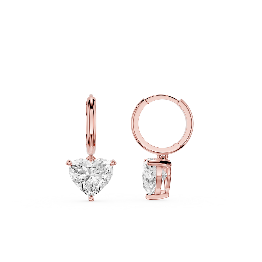 Rose gold hoop earrings with heart-shaped gemstones on a white background