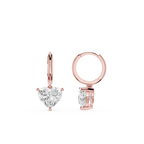 Rose gold hoop earrings with heart-shaped gemstones on a white background