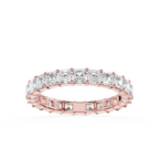A rose gold eternity ring featuring a continuous row of baguette-cut clear stones, shown on a clean white background.