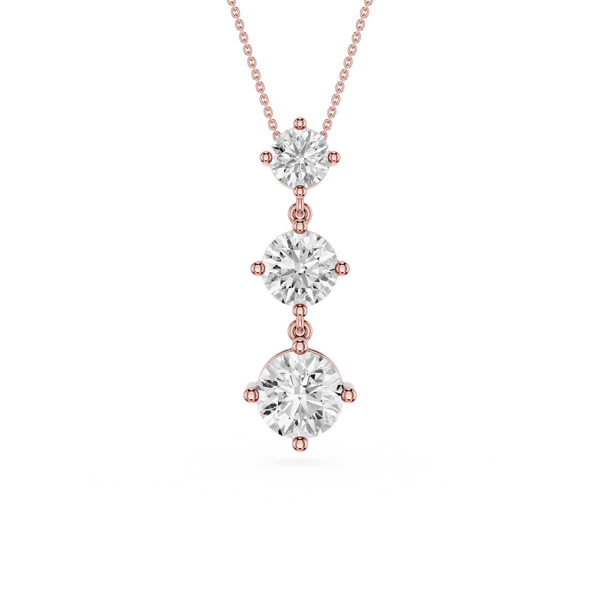 Rose gold necklace with three diamond pendants on a white background