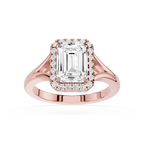 Rose gold ring with emerald-cut diamond and smaller diamonds on a white background