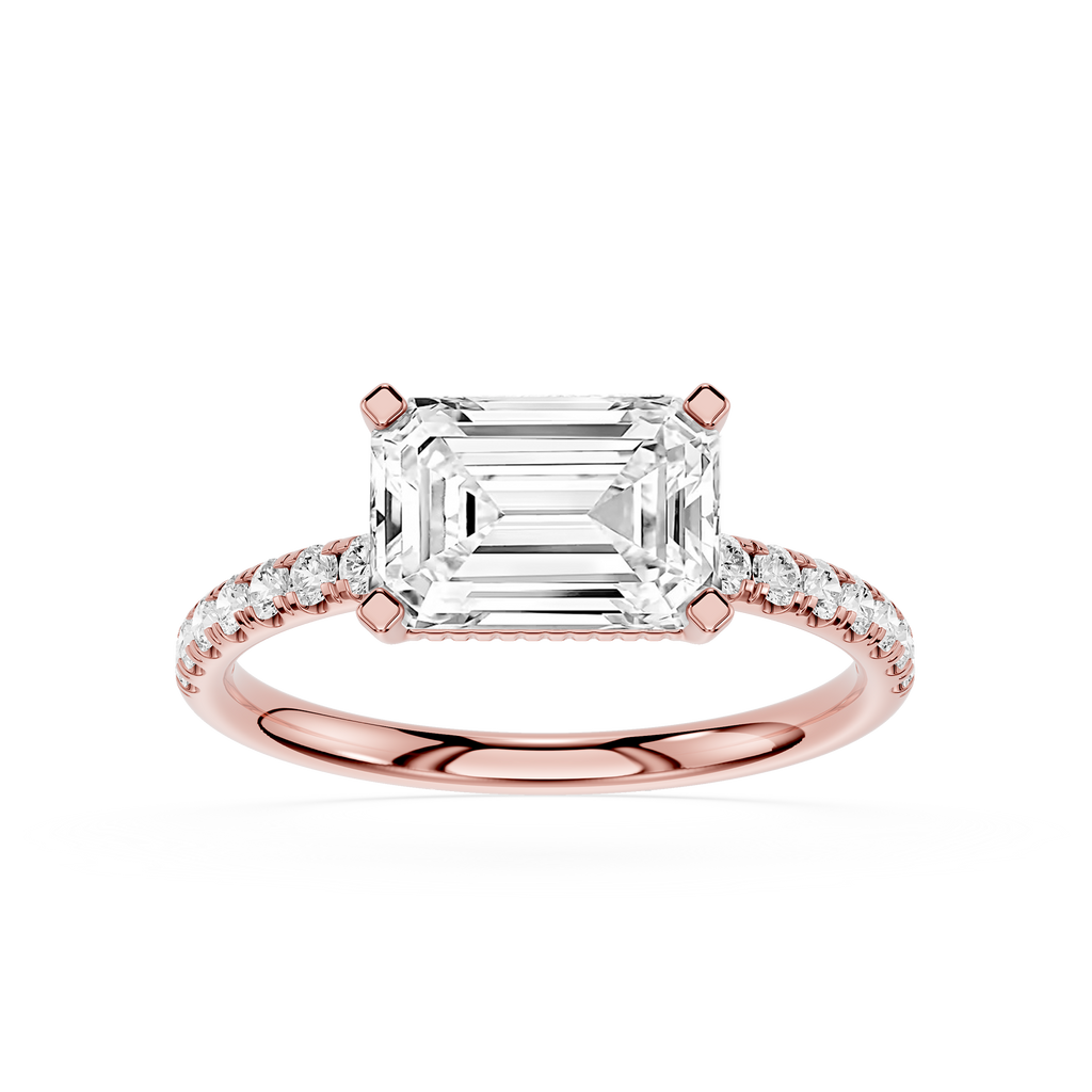 An emerald-cut diamond ring in rose gold with a pavé band, shown on a clean white background.
