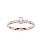 Rose gold ring with emerald-cut diamond and smaller diamonds on a white background