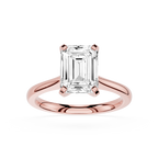 Rose gold ring with a large emerald-cut diamond on a white background