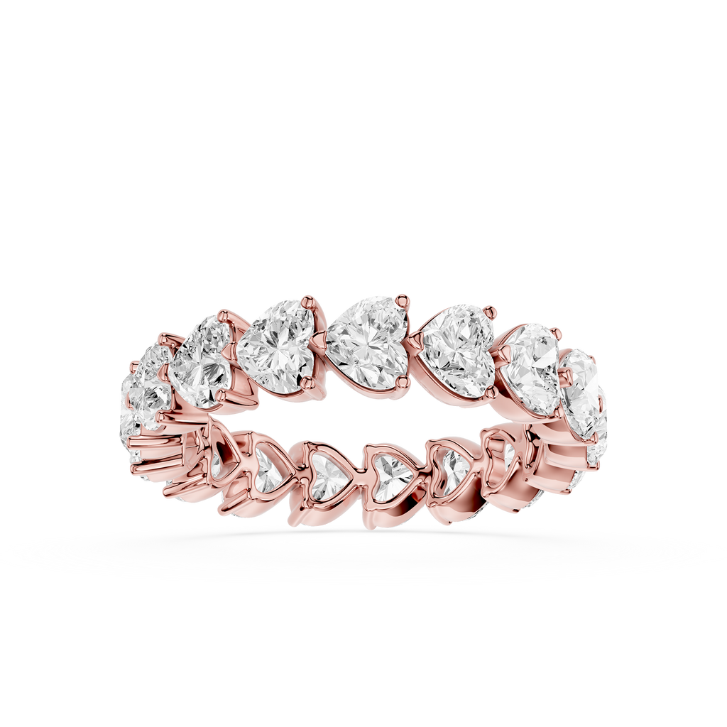 Rose gold ring with heart-shaped diamonds on a white background