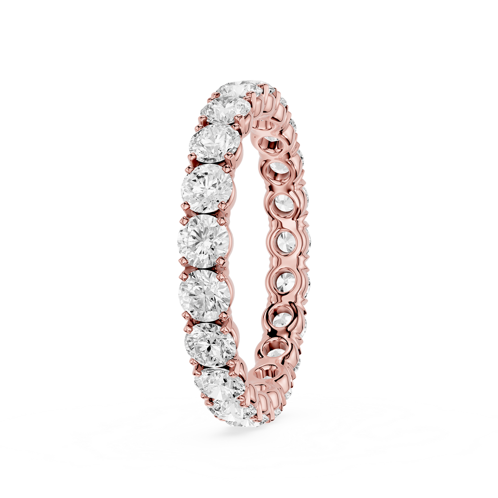 A rose gold eternity ring featuring a continuous row of round brilliant-cut clear diamonds on a white background.
