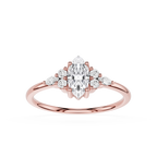 Rose gold ring with a marquise-shaped diamond and smaller diamonds on a white background