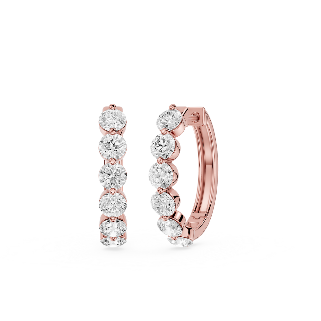 Rose gold hoop earrings with clear gemstones on a white background