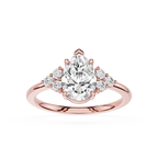 Rose gold ring with a pear-shaped diamond and smaller diamonds on a white background