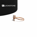 Rose gold split shank diamond ring with a pear cut solitaire, crossing pavé bands and delicate bow shaped detailing