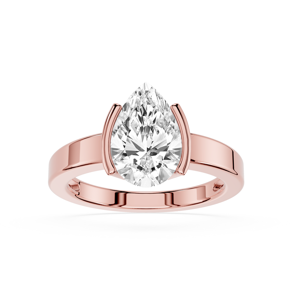 Rose gold ring with a pear-shaped diamond on a white background