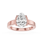 Rose gold ring with a pear-shaped diamond on a white background