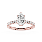 Rose gold ring with a pear-shaped diamond on a white background