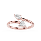 A rose gold ring with two triangular-cut clear gemstones, set against a clean white background.