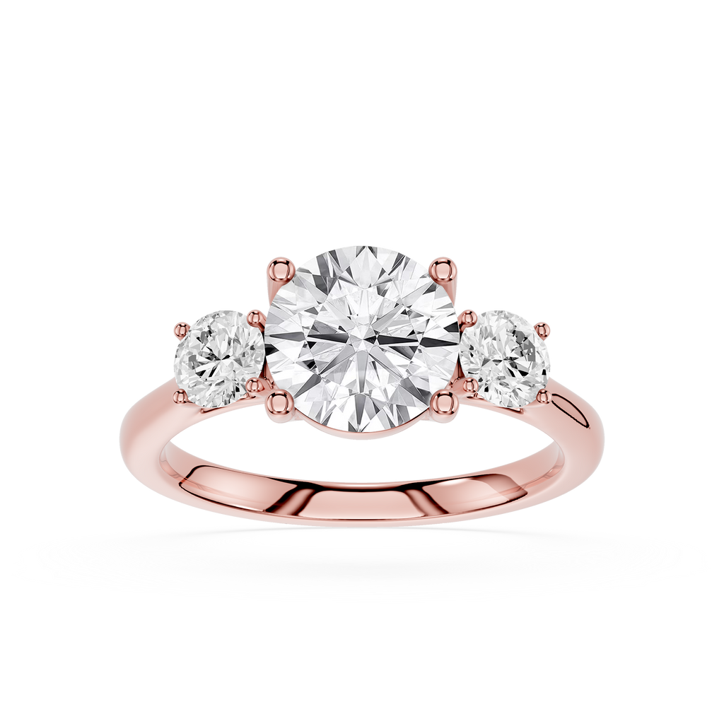 Rose gold ring with three diamonds on a white background
