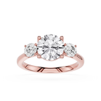 Rose gold ring with three diamonds on a white background