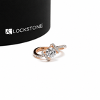 Rose gold round cut lab grown diamond engagement ring featuring a prong set solitaire and intertwined pavé diamond bands