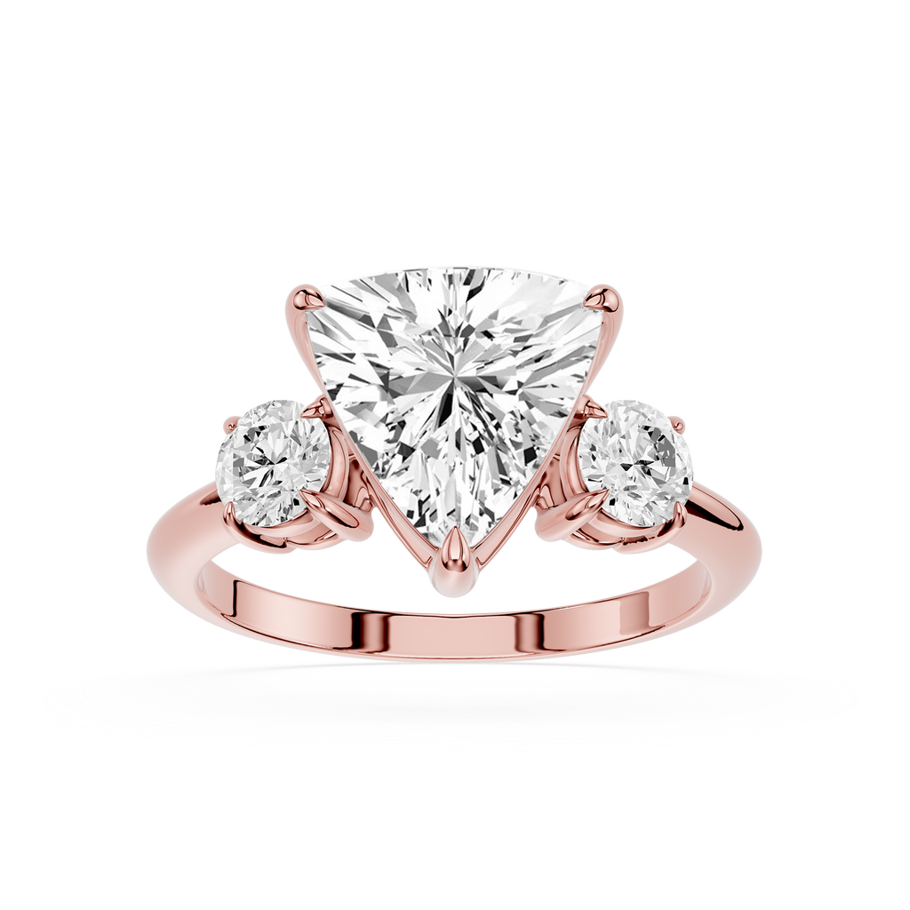 Rose gold ring with a heart-shaped diamond and two round diamonds on a white background