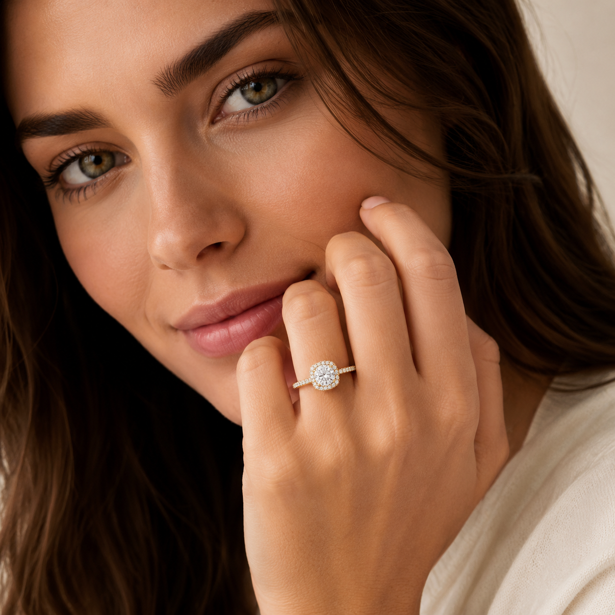 Woman wearing a diamond ring on her finger with a soft focus background