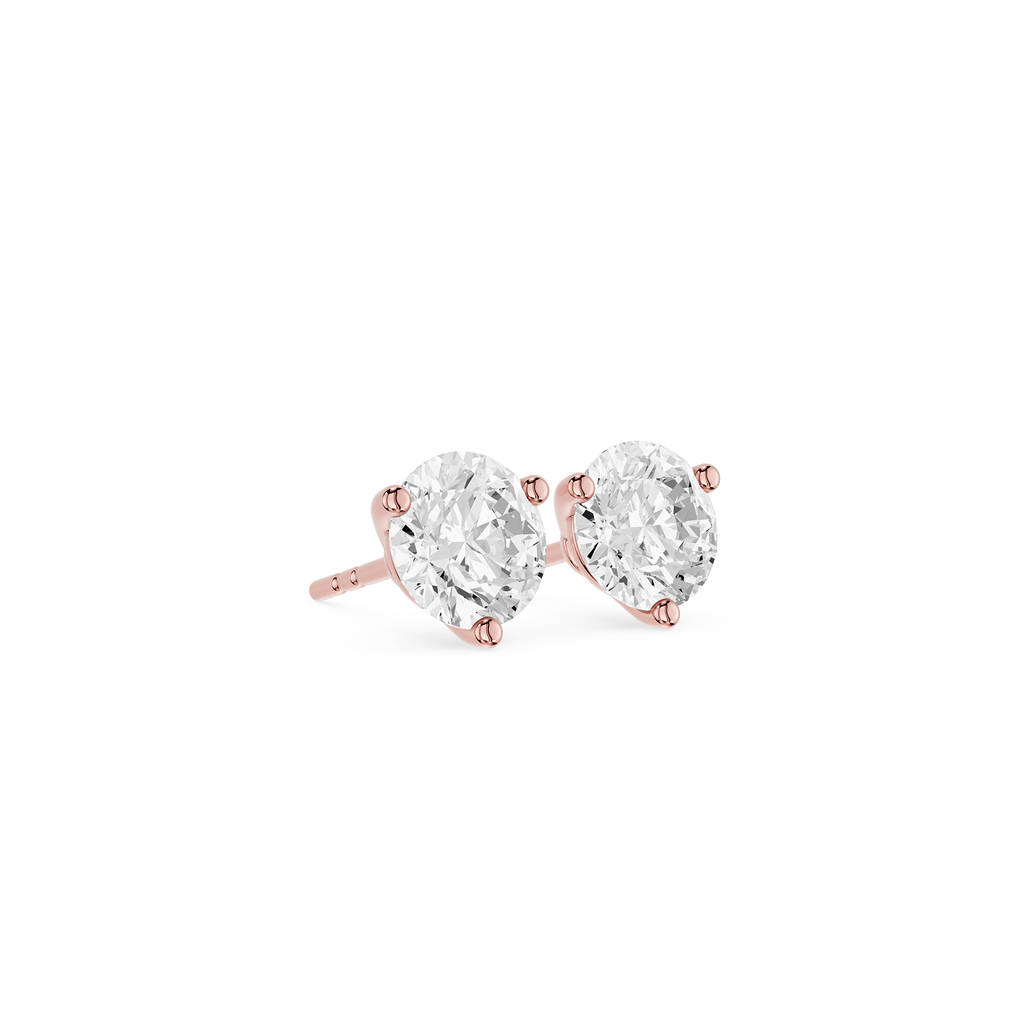 Rose gold earrings with clear gemstones on a white background
