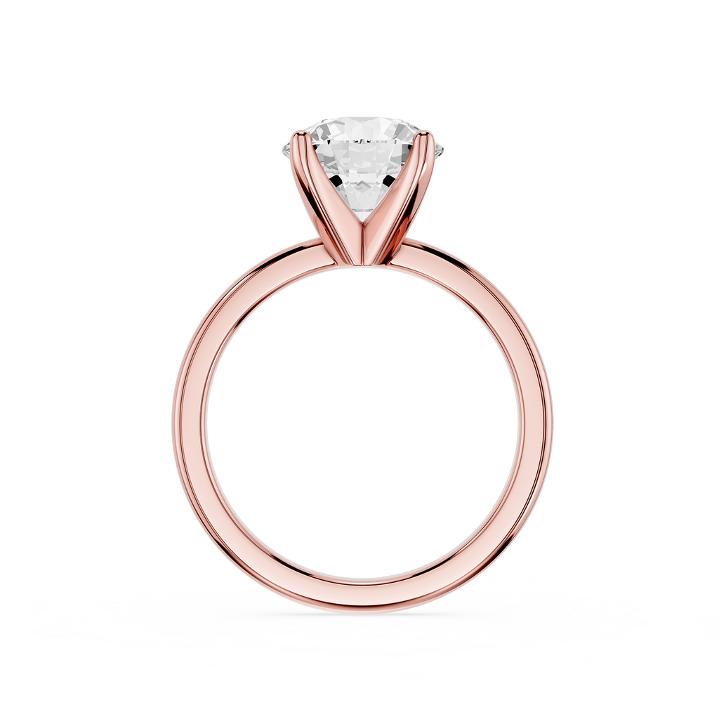 Rose gold ring with a clear gemstone on a white background