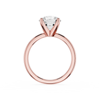 Rose gold ring with a clear gemstone on a white background