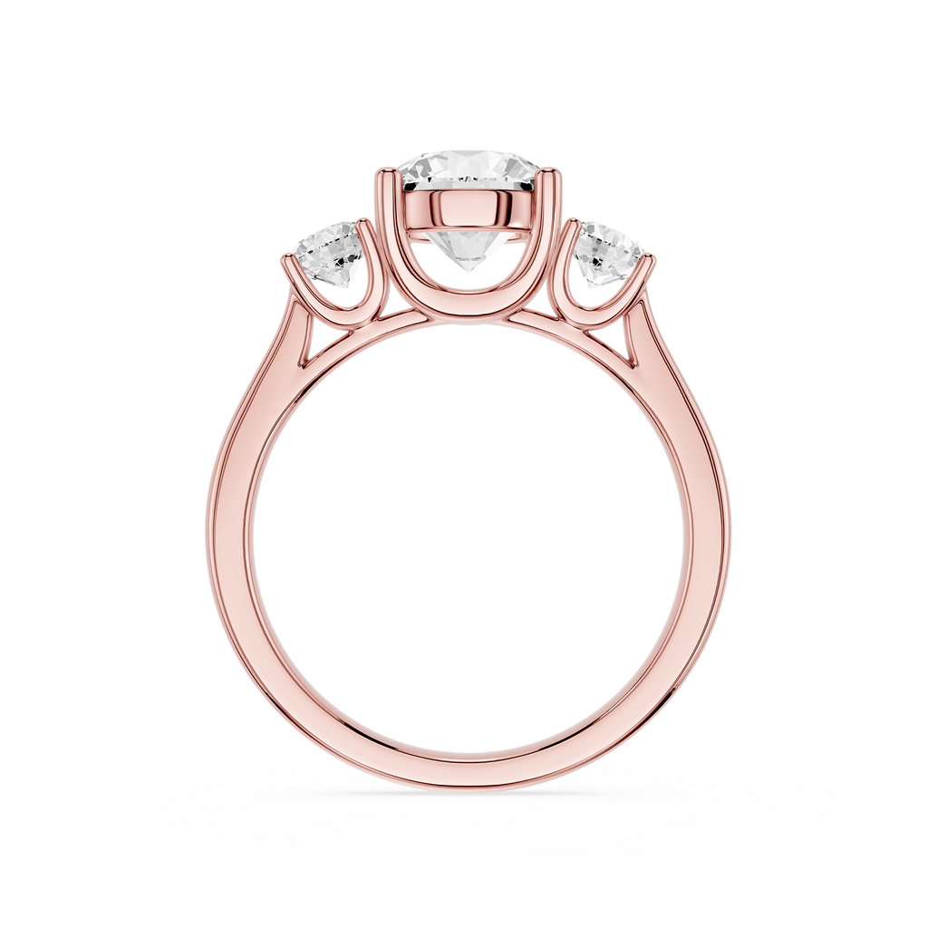 Rose gold ring with three diamonds on a white background