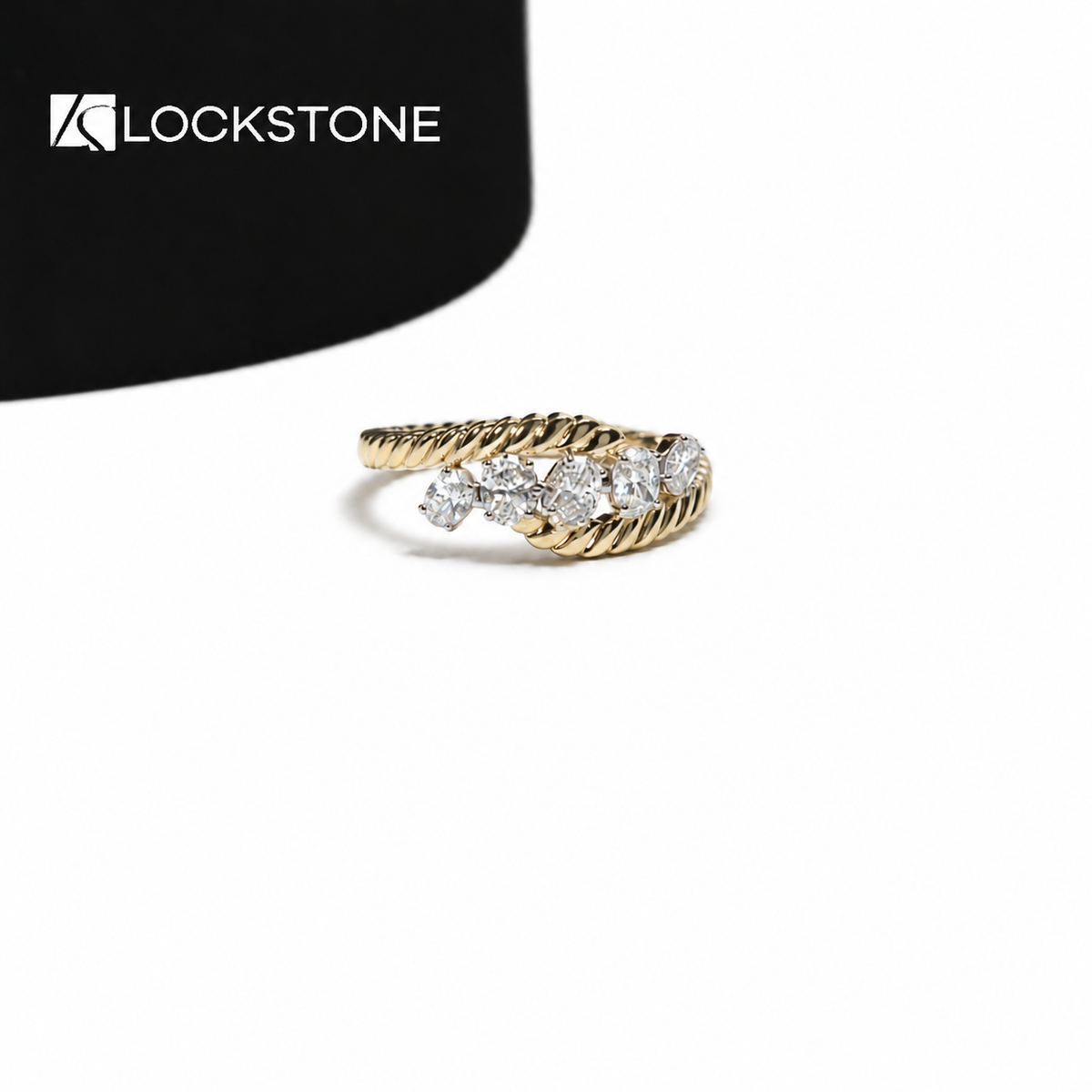 Yellow gold five stone lab grown diamond ring featuring round cut diamonds and a twisted rope style crossover band