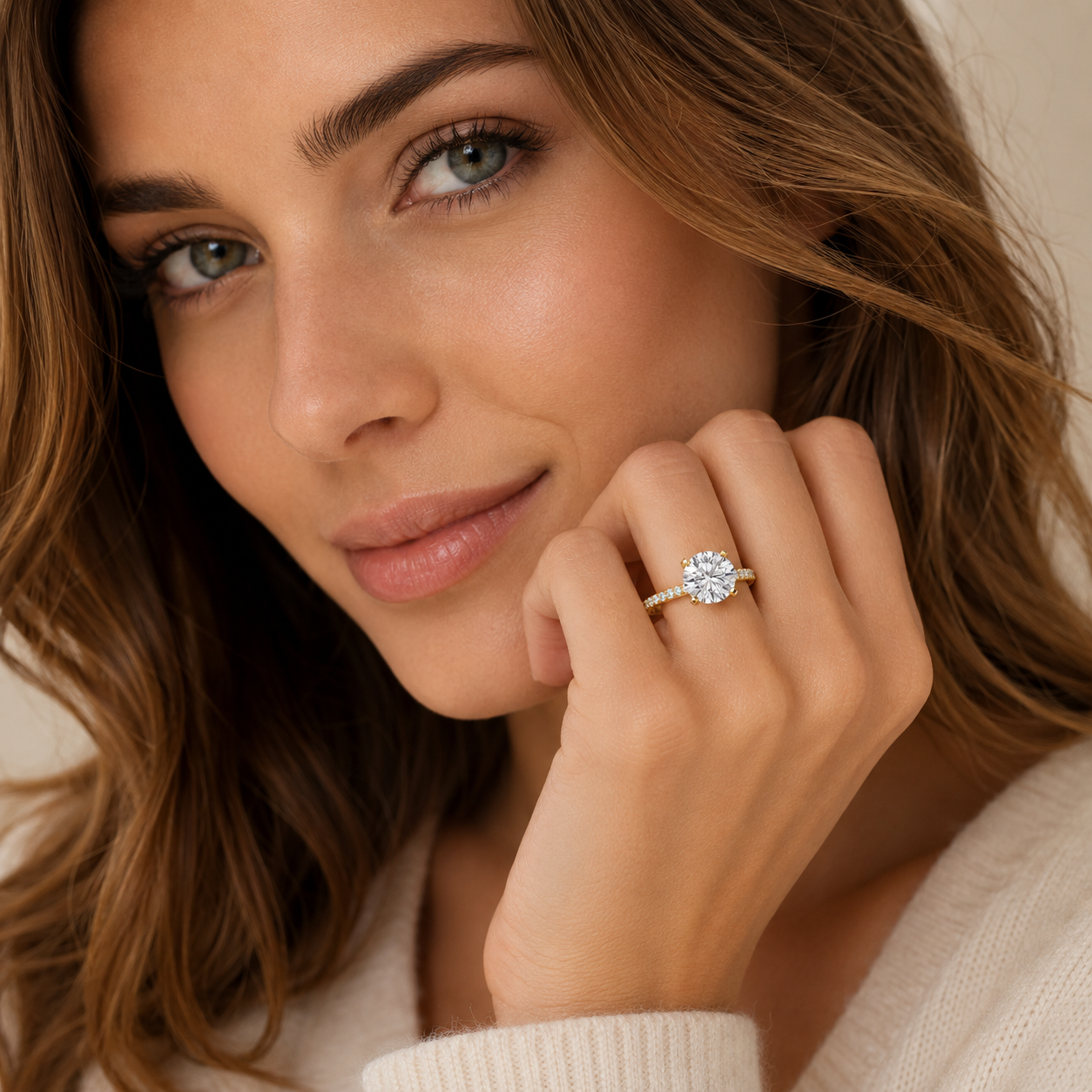 Woman wearing a diamond ring with a neutral background