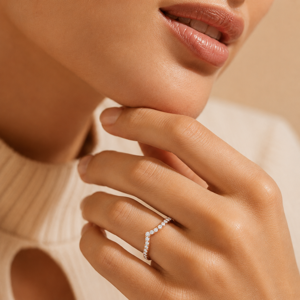 Close-up of a hand wearing a diamond ring with a blurred background