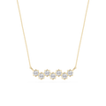 Gold necklace with diamond-like stones on a white background