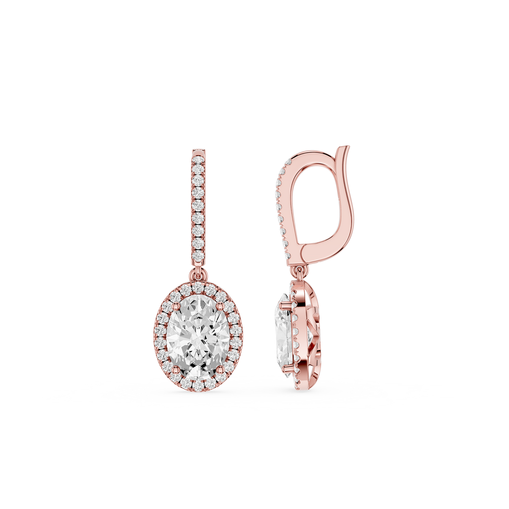 Rose gold earrings with clear gemstones on a white background