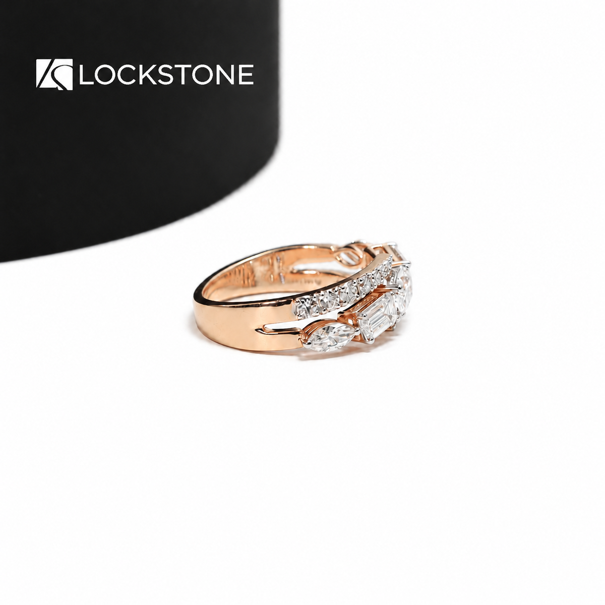 Rose gold diamond wrap ring displaying prong set oval and emerald cut diamonds alongside sweeping pavé accented shoulders